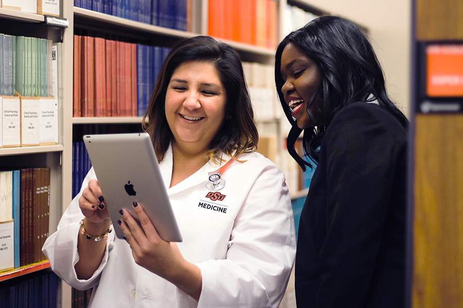 Faculty and student in the library Faculty and student in the library