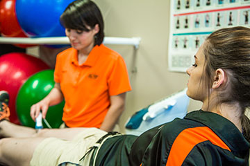 Athletic training and medical student working together