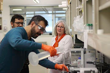 Faculty oversees students in laboratory