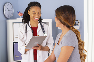 Physican assistant speaks with patient