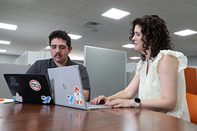 Two medical students conducting research on their laptops. Two medical students conducting research on their laptops.