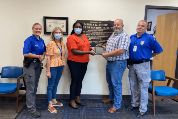 Presenting iPads to the Okmulgee County Jail; F&CS Case Manager Jena Moore 2nd from left; Project Manager Chetana Musapeta 3rd from left